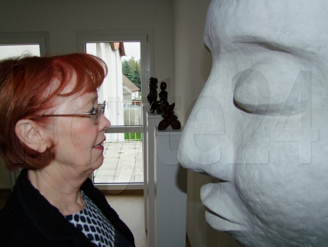 Gisela Thielmann mit einer überdimensionalen Gesichts-Halbplastik, die Bestandteil der Ausstellung ist. Foto: Rainer Könen