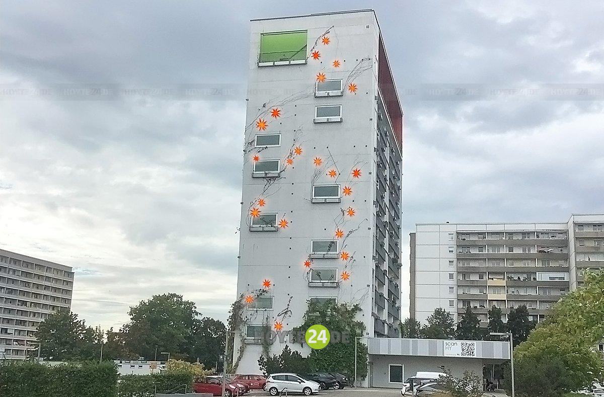Man sieht das Hochhaus Stadtpromenade 11 mit durch Computertechnik eingefügten Herrnhuter Sternen.