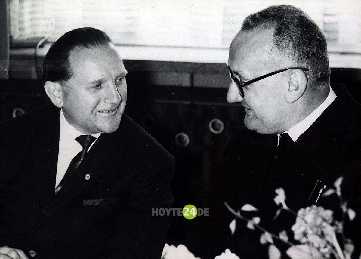 Man sieht Arno Pinkau im Gespräch mit einem anderen Mann,