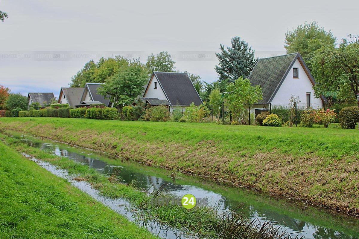 Man sieht die Bungalowsiedlung und davor das Schwarzwasser.
